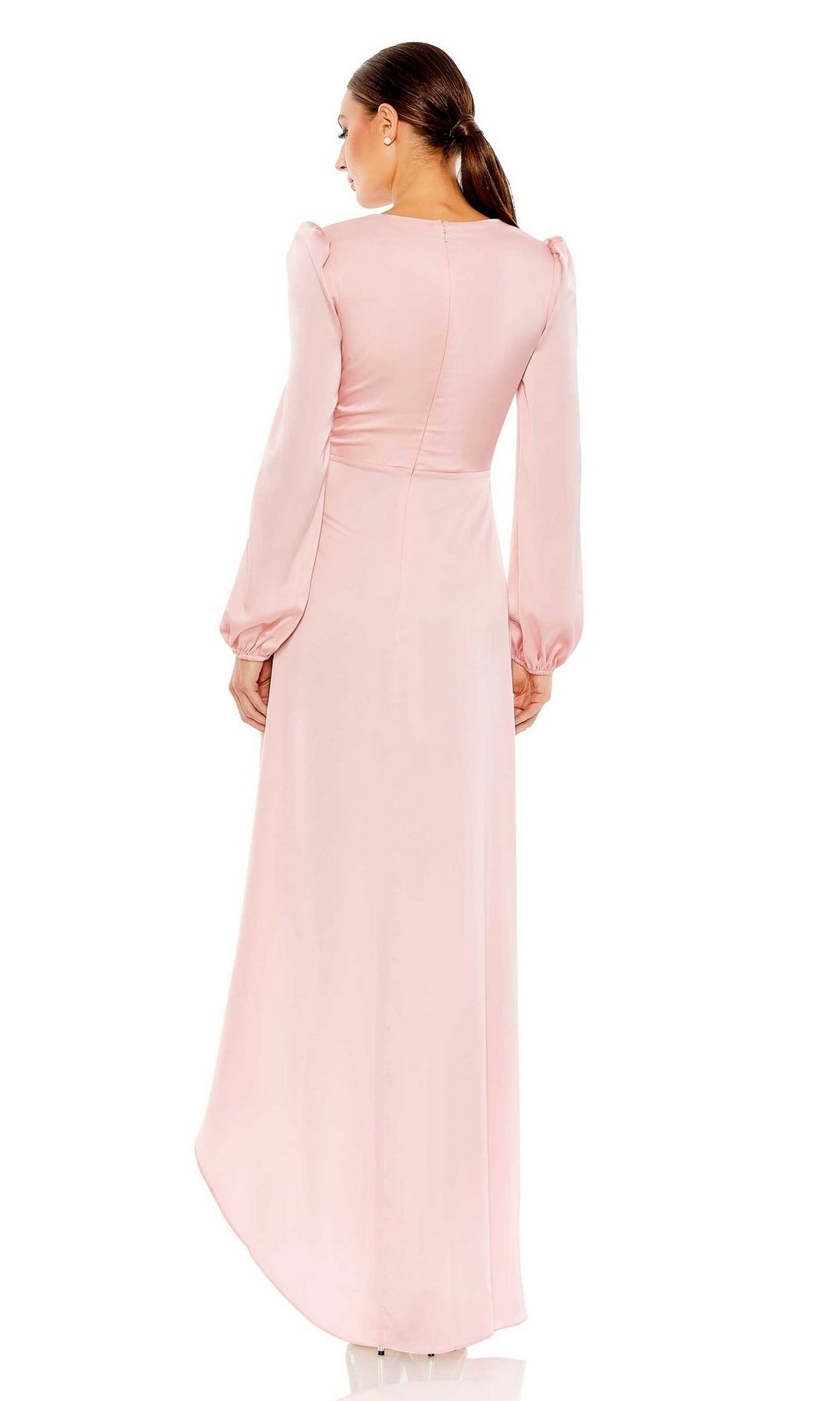 A woman with a low ponytail models the Long Formal Dress 55624 by Mac Duggal—pale pink, floor-length, with long puff sleeves—shown from the back against a white background.